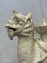 A Chinese Dehua blanc de Chine candlestick in the form a qilin, Kangxi