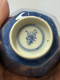 A pair of Chinese gilt-decorated powder-blue-ground 'Antiquities' cups and saucers, lingzhi mark, Kangxi