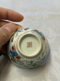 Two Dutch-decorated Chinese cups and saucers with parrots among flowering branches, 18th C.