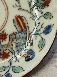 Two Dutch-decorated Chinese cups and saucers with parrots among flowering branches, 18th C.