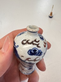 A Chinese blue, white and copper-red 'Dragon' snuff bottle, 19th C.
