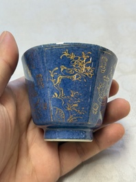 A pair of Chinese gilt-decorated powder-blue-ground 'Antiquities' cups and saucers, lingzhi mark, Kangxi