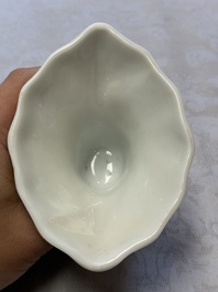 A Chinese Dehua blanc de Chine 'Dragon, Carp, Crane and Deer' libation cup, Kangxi