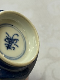 A pair of Chinese gilt-decorated powder-blue-ground 'Antiquities' cups and saucers, lingzhi mark, Kangxi