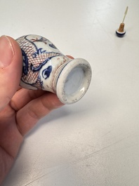 A Chinese blue, white and copper-red 'Dragon' snuff bottle, 19th C.