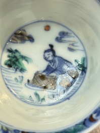 A Chinese European-decorated blue and white 'Fisherman' cup and saucer, Kangxi