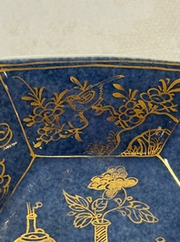 A pair of Chinese gilt-decorated powder-blue-ground 'Antiquities' cups and saucers, lingzhi mark, Kangxi