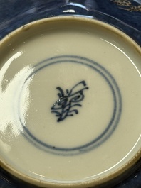 A pair of Chinese gilt-decorated powder-blue-ground 'Antiquities' cups and saucers, lingzhi mark, Kangxi