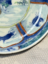 A Chinese European-decorated blue and white 'Fisherman' cup and saucer, Kangxi