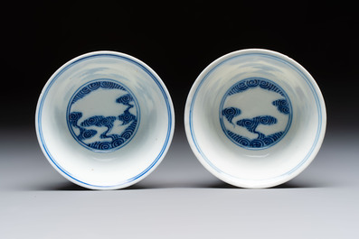 A pair of Chinese inscribed blue and white 'Clouds' tea bowls, covers and stands, Guangxu mark and of the period