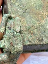 A Chinese archaic bronze cosmetic box standing on four stylised buffalo-form feet, Lian 奩, Eastern Zhou/Spring and Autumn