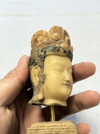 A rare Chinese polychrome carved white marble head of a Bodhisattva on a stand, Northern Qi