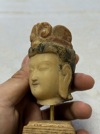A rare Chinese polychrome carved white marble head of a Bodhisattva on a stand, Northern Qi