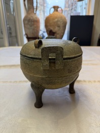 A Chinese archaic bronze tripod food vessel and cover, Ding 鼎, Eastern Zhou