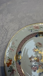 A Chinese famille rose gilt-decorated 'Antiquities' plate, Yongzheng