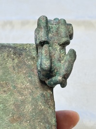 A Chinese archaic bronze cosmetic box standing on four stylised buffalo-form feet, Lian 奩, Eastern Zhou/Spring and Autumn
