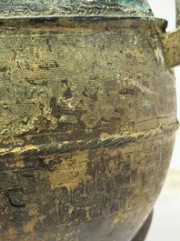 A Chinese archaic bronze tripod food vessel and cover, Ding 鼎, Eastern Zhou