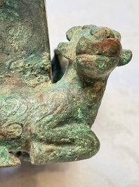 A Chinese archaic bronze cosmetic box standing on four stylised buffalo-form feet, Lian 奩, Eastern Zhou/Spring and Autumn