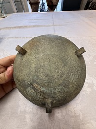 A Chinese archaic bronze tripod food vessel and cover, Ding 鼎, Eastern Zhou