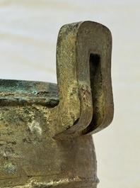 A Chinese archaic bronze tripod food vessel and cover, Ding 鼎, Eastern Zhou