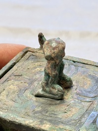 A Chinese archaic bronze cosmetic box standing on four stylised buffalo-form feet, Lian 奩, Eastern Zhou/Spring and Autumn