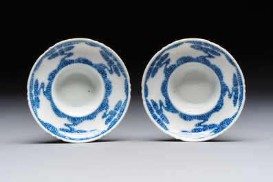 A pair of Chinese inscribed blue and white 'Clouds' tea bowls, covers and stands, Guangxu mark and of the period