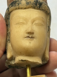 A rare Chinese polychrome carved white marble head of a Bodhisattva on a stand, Northern Qi
