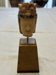A rare Chinese polychrome carved white marble head of a Bodhisattva on a stand, Northern Qi