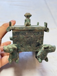 A Chinese archaic bronze cosmetic box standing on four stylised buffalo-form feet, Lian 奩, Eastern Zhou/Spring and Autumn