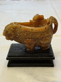 A Chinese precious-stone-inlaid carved soapstone wine vessel on stand, Gong 觥, Republic