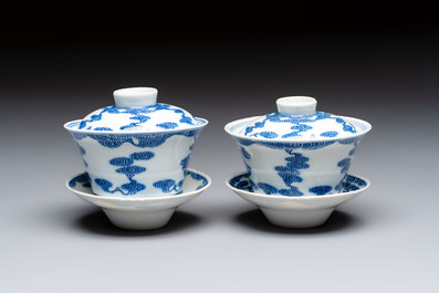 A pair of Chinese inscribed blue and white 'Clouds' tea bowls, covers and stands, Guangxu mark and of the period