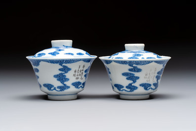 A pair of Chinese inscribed blue and white 'Clouds' tea bowls, covers and stands, Guangxu mark and of the period