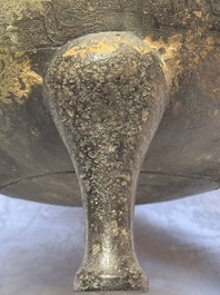 A Chinese archaic bronze tripod food vessel and cover, Ding 鼎, Eastern Zhou