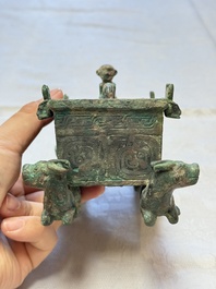 A Chinese archaic bronze cosmetic box standing on four stylised buffalo-form feet, Lian 奩, Eastern Zhou/Spring and Autumn