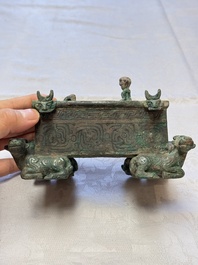 A Chinese archaic bronze cosmetic box standing on four stylised buffalo-form feet, Lian 奩, Eastern Zhou/Spring and Autumn