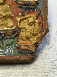 A gilt polychrome stucco votive plaque, Tsha Tsha, Tibet, 18/19th C.
