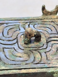 A Chinese archaic bronze cosmetic box standing on four stylised buffalo-form feet, Lian 奩, Eastern Zhou/Spring and Autumn