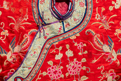 A Chinese embroidered silk red-ground women's robe, 19th C.