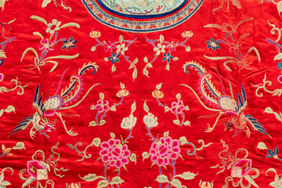 A Chinese embroidered silk red-ground women's robe, 19th C.