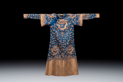 A Chinese embroidered silk blue-ground 'Dragons' robe, adapted into a lady's dress, 19th C. and later