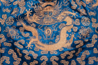 A Chinese embroidered silk blue-ground 'Dragons' robe, adapted into a lady's dress, 19th C. and later
