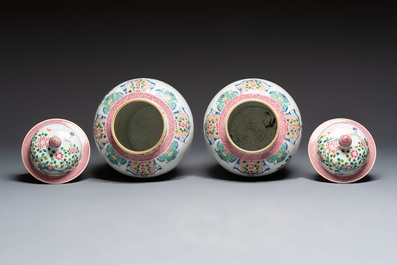 A pair of Chinese famille rose 'Phoenixes among Flowering Branches' vases and covers, 20th C.