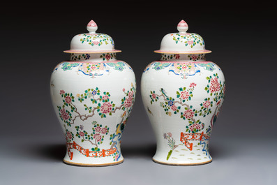 A pair of Chinese famille rose 'Phoenixes among Flowering Branches' vases and covers, 20th C.