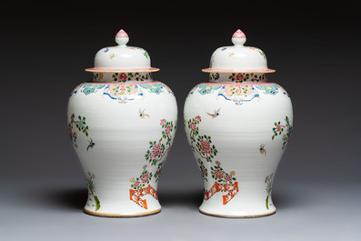 A pair of Chinese famille rose 'Phoenixes among Flowering Branches' vases and covers, 20th C.