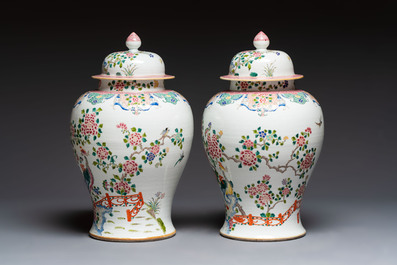 A pair of Chinese famille rose 'Phoenixes among Flowering Branches' vases and covers, 20th C.
