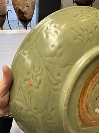 A rare and large Chinese Longquan celadon dish with floral design, Ming, early 15th C.