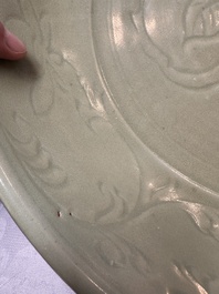 A rare and large Chinese Longquan celadon dish with floral design, Ming, early 15th C.