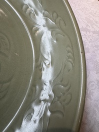 A rare and large Chinese Longquan celadon dish with floral design, Ming, early 15th C.