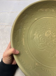 A rare and large Chinese Longquan celadon dish with floral design, Ming, early 15th C.