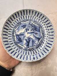 Four Chinese 'Kraak' blue and white plates with a bird on a rock, Wanli